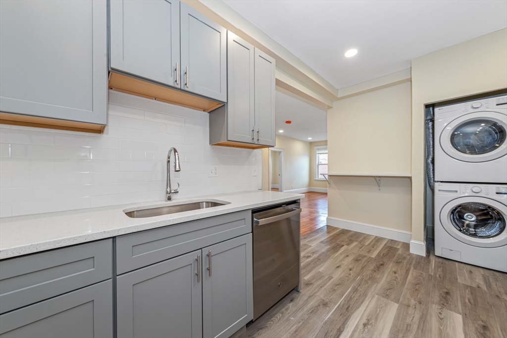 44 Brackett Street, Unit 3 Boston, MA 02135 - Photo 4 of 27 a kitchen with a sink a stove and cabinets