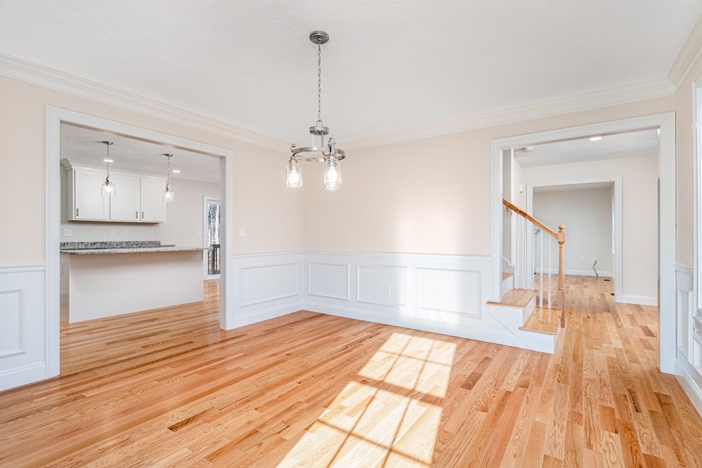 512 Northfield Road Lunenburg, MA 01462 - Photo 17 of 33 a view of empty room with wooden floor and kitchen view