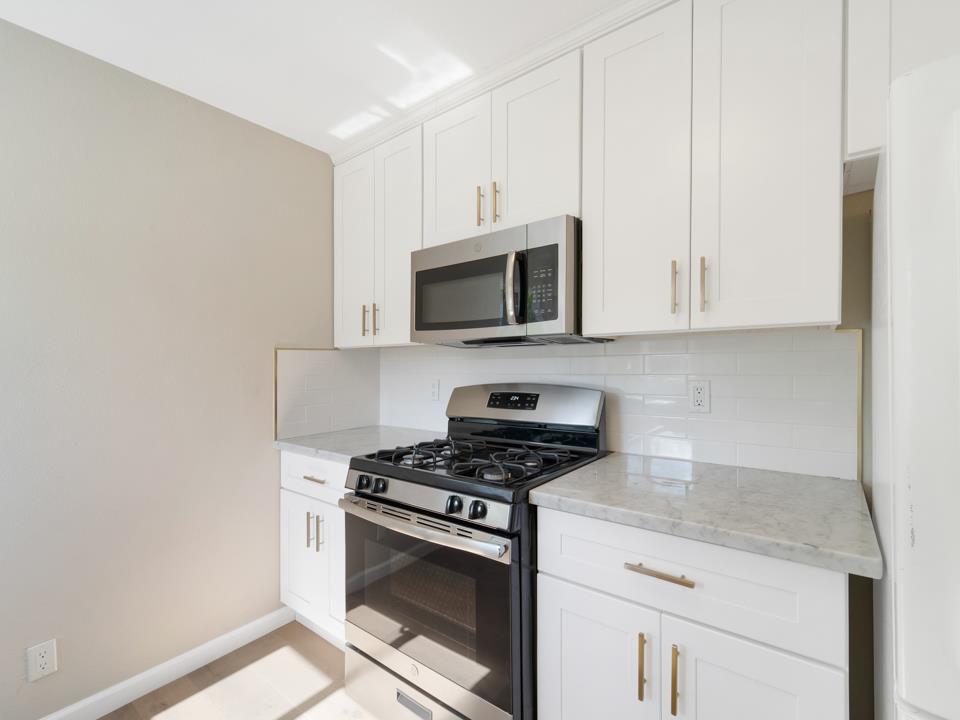 22824 High Street Hayward, CA 94541 - Photo 11 of 23 a kitchen with granite countertop white cabinets and stainless steel appliances