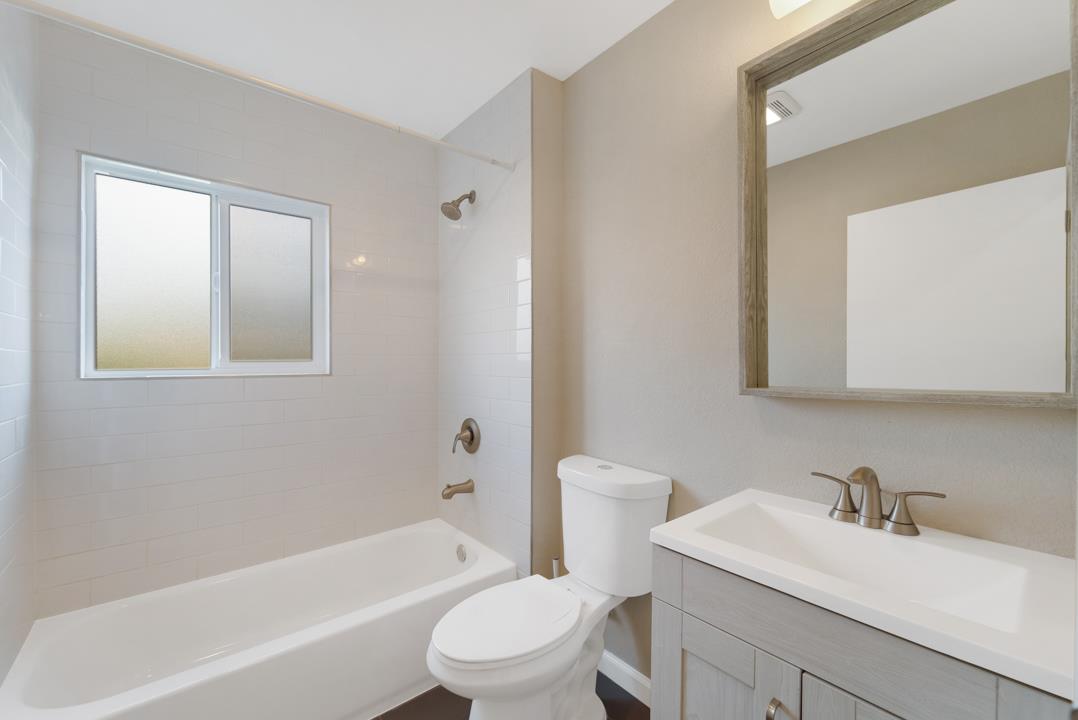 22824 High Street Hayward, CA 94541 - Photo 16 of 23 a bathroom with a granite countertop sink toilet a mirror and bathtub