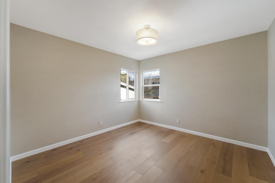 22824 High Street Hayward, CA 94541 - Photo 17 of 23 an empty room with windows and chandelier fan