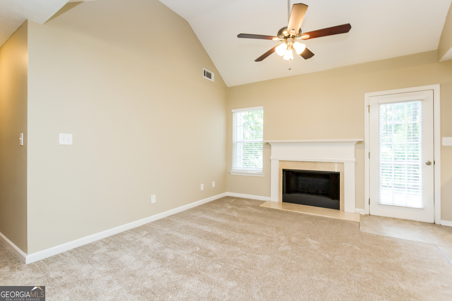 308 Barr Circle Rex, GA 30273 - Photo 4 of 15 a view of empty room with a fireplace and a ceiling fan