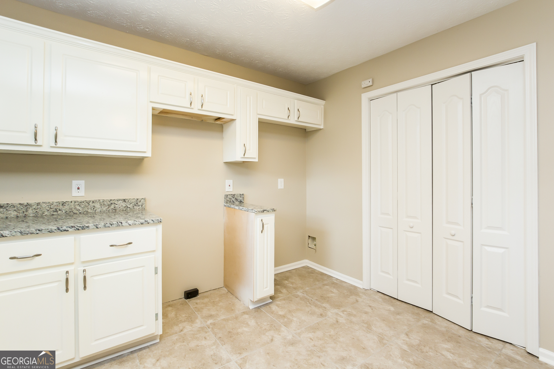 308 Barr Circle Rex, GA 30273 - Photo 5 of 15 a view of a kitchen with white cabinets and wooden floor