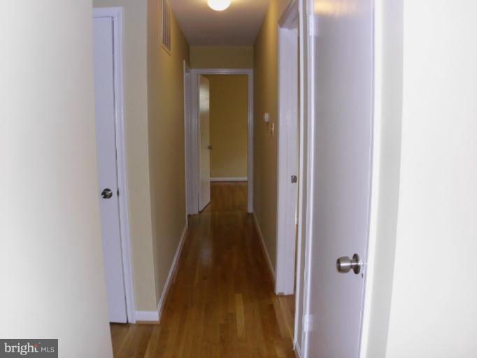 5511 Rolling Road Springfield, VA 22151 - Photo 14 of 17 a view of a hallway with the wooden floor