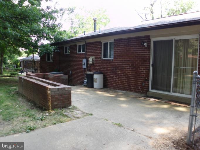 5511 Rolling Road Springfield, VA 22151 - Photo 5 of 17 a view of a patio with couches chairs and a fire pit