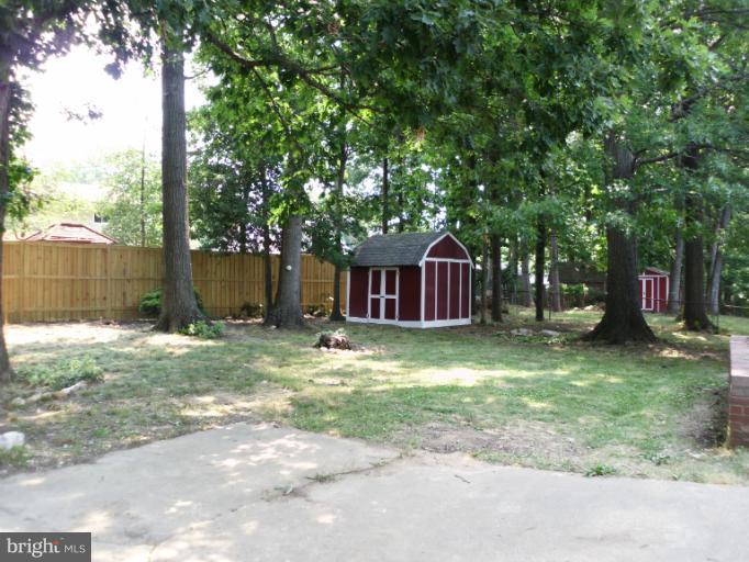 5511 Rolling Road Springfield, VA 22151 - Photo 8 of 17 a view of a yard with a large tree and a yard