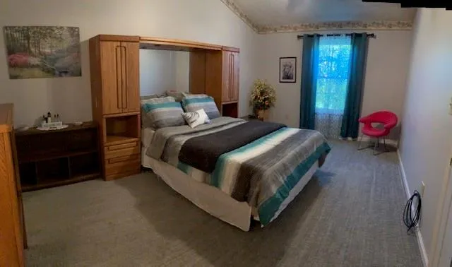 a spacious bedroom with a bed and a dresser