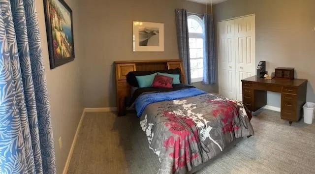 a bedroom with a bed and a table