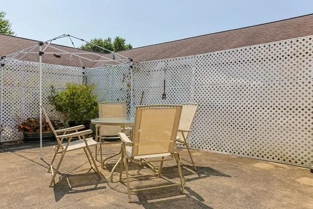 a view of a patio with table and chairs