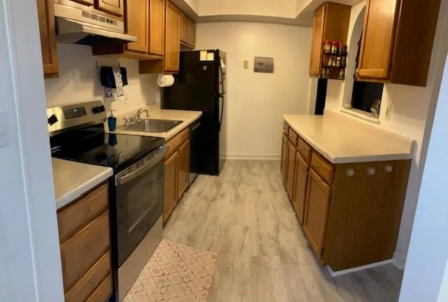 a kitchen with a sink stove and refrigerator