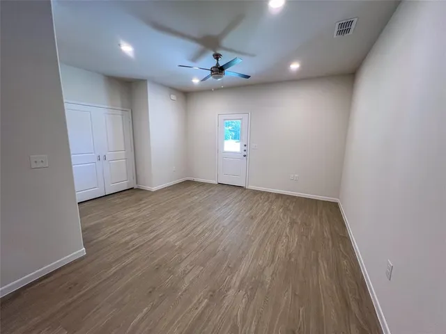 a view of a room with wooden floor and window