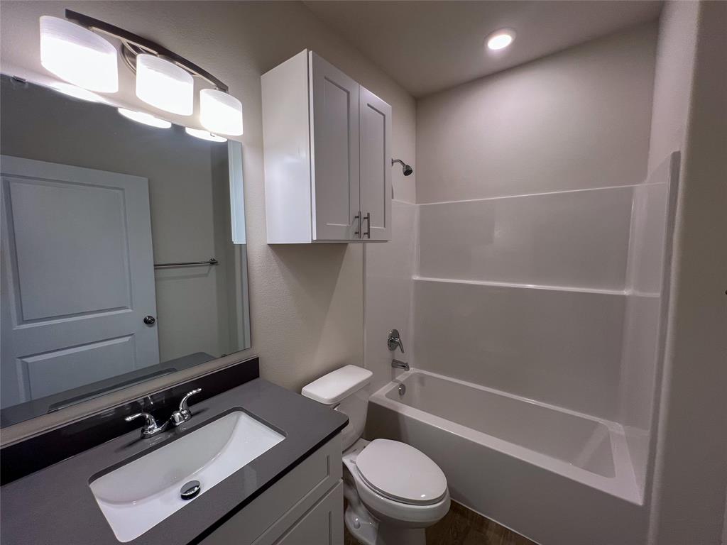 3050 Viking Street Denison, TX 75020 - Photo 10 of 17 a bathroom with a sink a toilet and shower