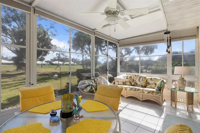 a living room with furniture and floor to ceiling windows