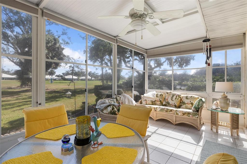 276 Cerromar Way South, Unit 60 Venice, FL 34293 - Photo 13 of 31 a living room with patio furniture and a floor to ceiling window