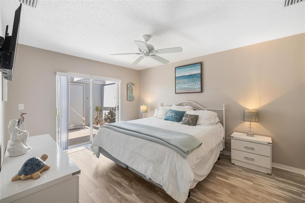 276 Cerromar Way South, Unit 60 Venice, FL 34293 - Photo 16 of 31 a bedroom with a bed and a chandelier