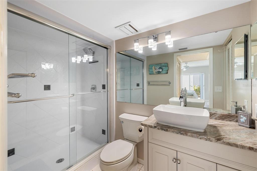 276 Cerromar Way South, Unit 60 Venice, FL 34293 - Photo 20 of 31 a bathroom with a sink a toilet and shower