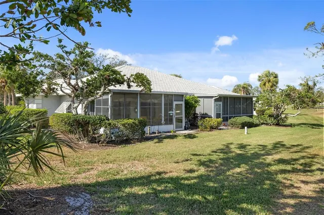 a view of house with swimming pool and yard