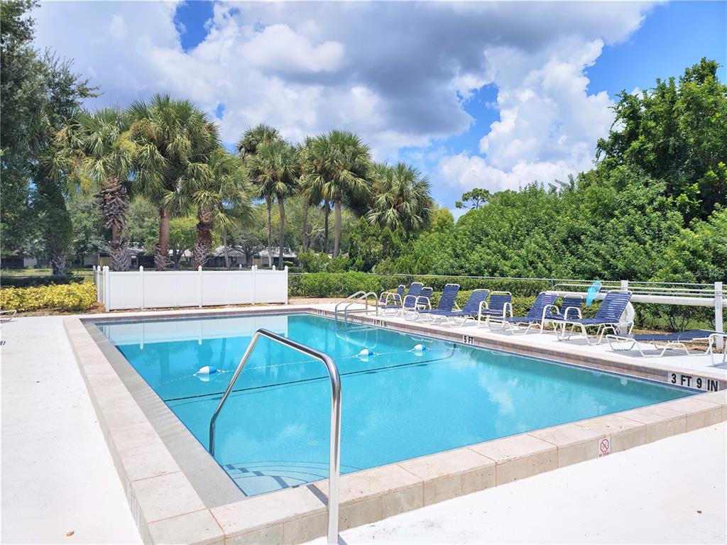 276 Cerromar Way South, Unit 60 Venice, FL 34293 - Photo 27 of 31 a view of house with swimming pool and yard