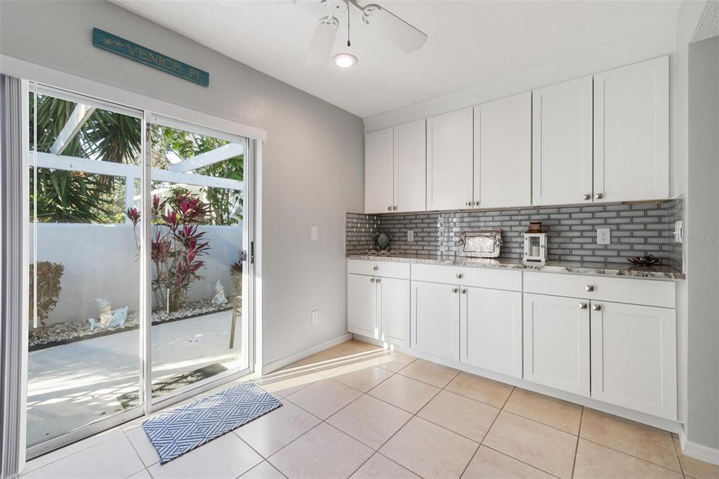 276 Cerromar Way South, Unit 60 Venice, FL 34293 - Photo 7 of 31 a kitchen with white cabinets and window