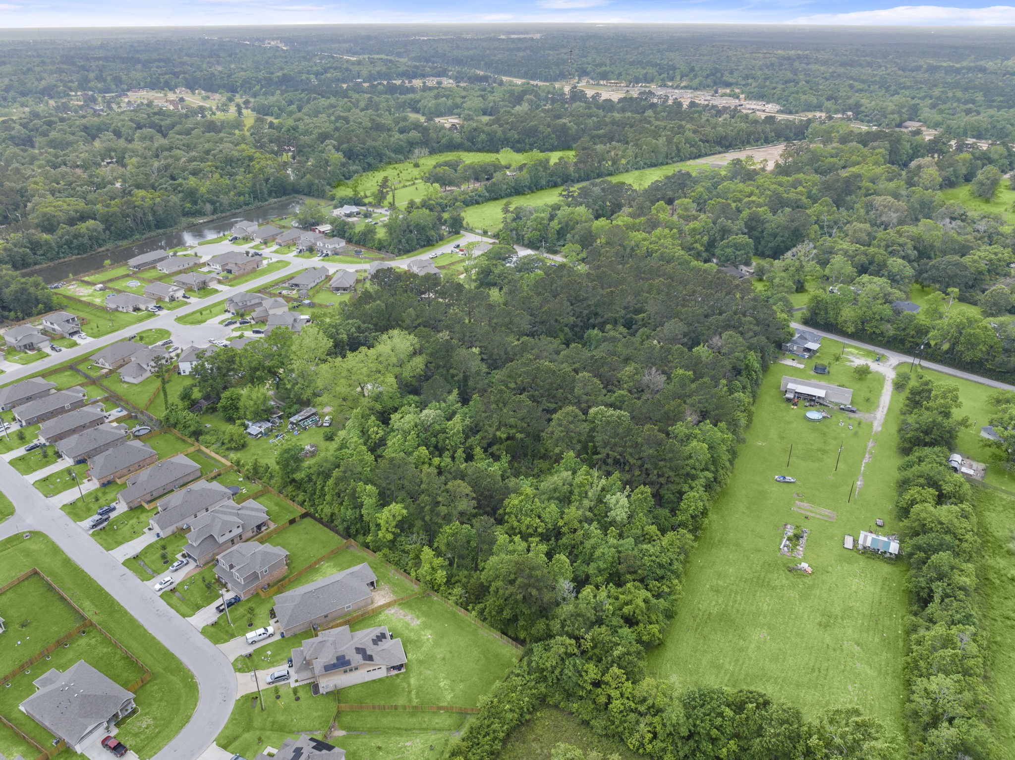 15399 Memorial Drive Splendora, TX 77372 - Photo 12 of 15 an aerial view of residential houses with outdoor space and trees