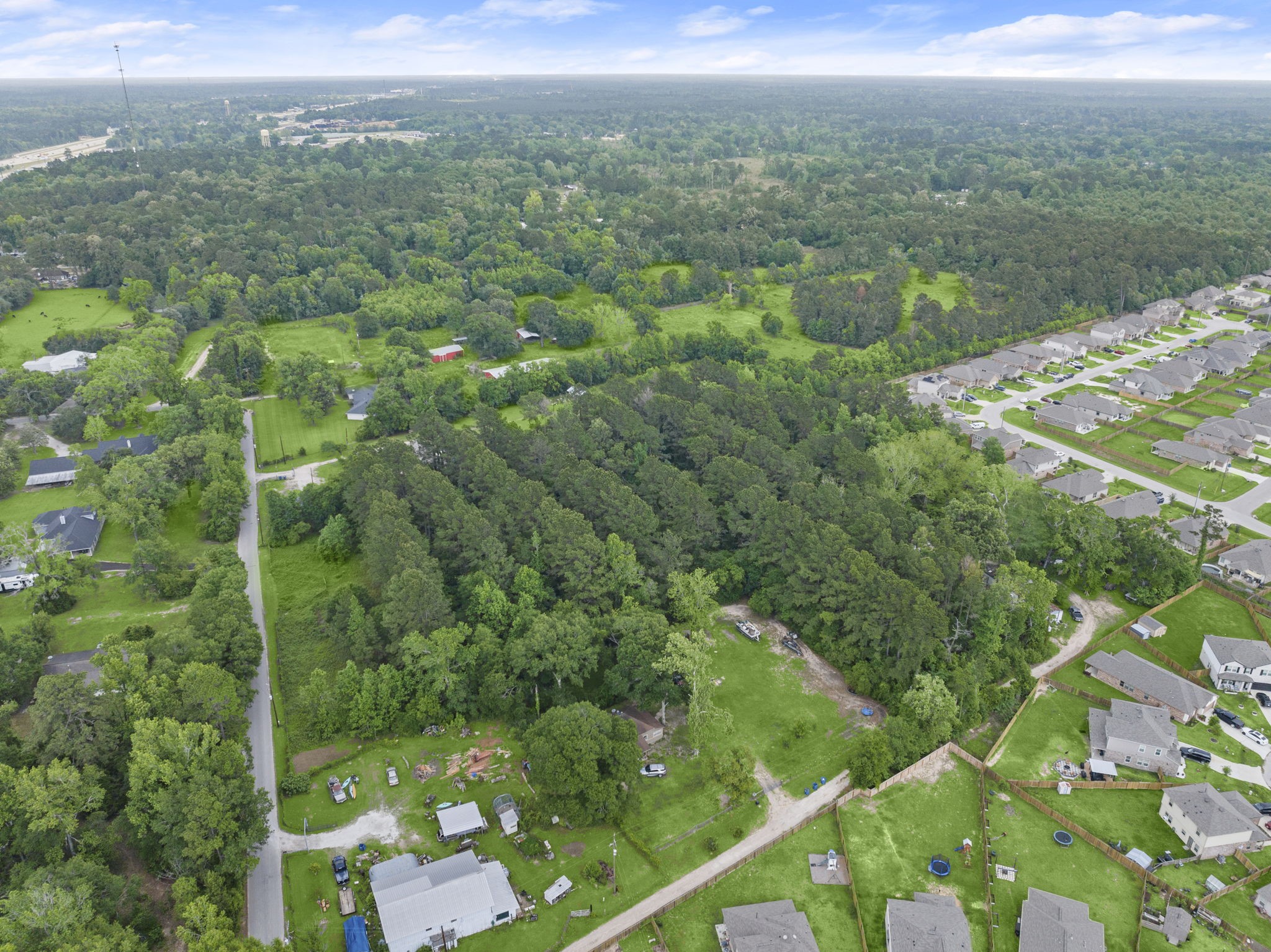 15399 Memorial Drive Splendora, TX 77372 - Photo 8 of 15 a view of a city with lush green forest