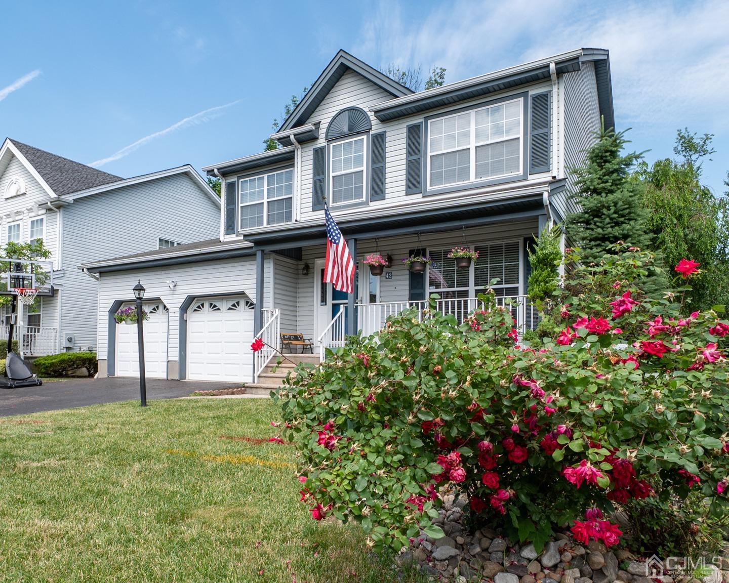 a front view of a house with a porch and a yard