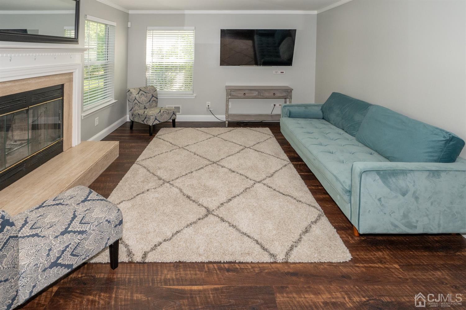 42 Springfield Road North Brunswick, NJ 08902 - Photo 11 of 37 a living room with furniture and a flat screen tv