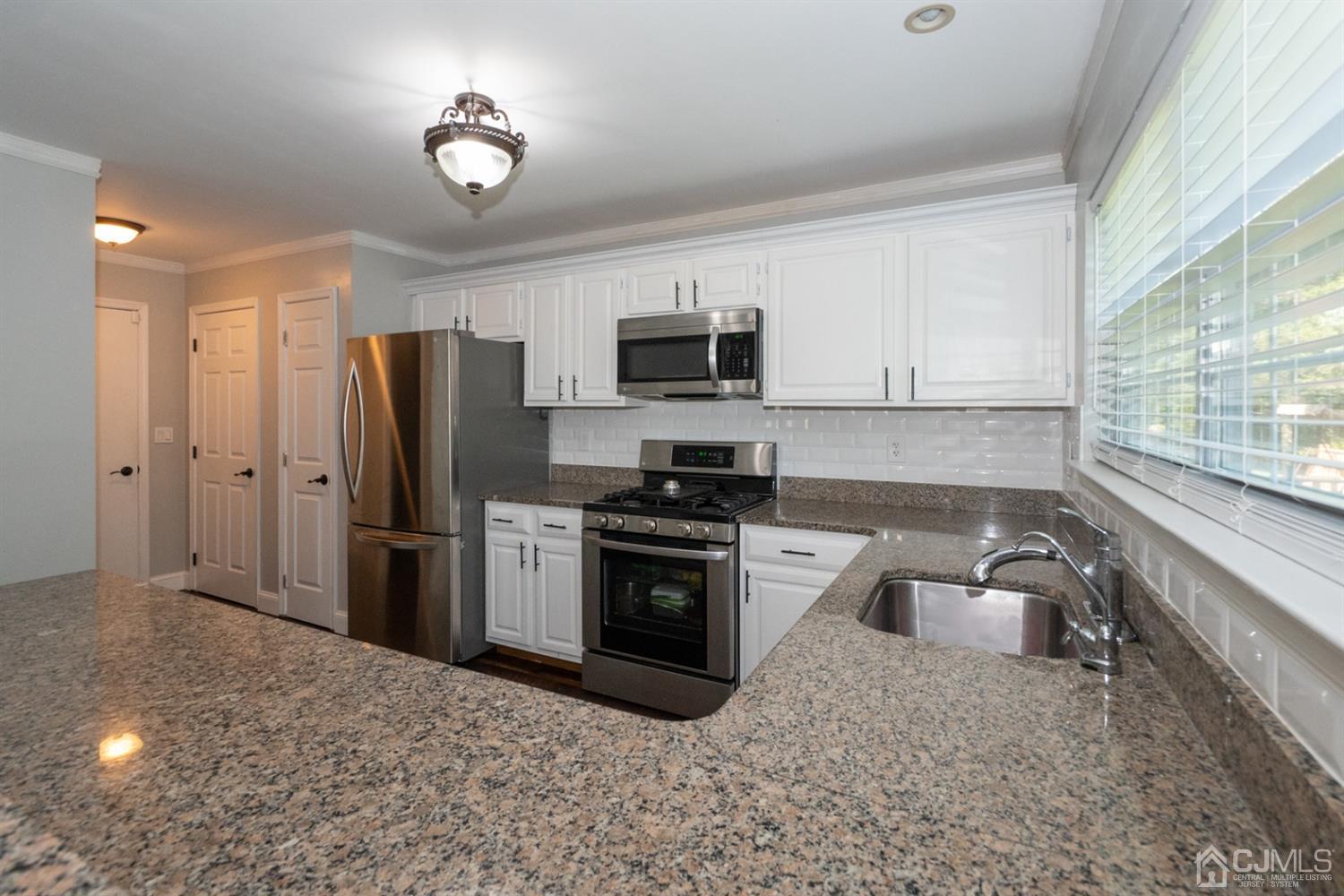 42 Springfield Road North Brunswick, NJ 08902 - Photo 17 of 37 a kitchen with a refrigerator stove and microwave