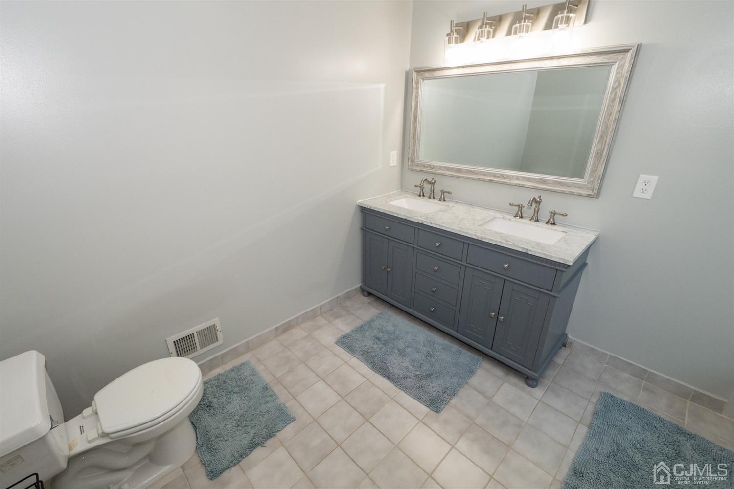 42 Springfield Road North Brunswick, NJ 08902 - Photo 26 of 37 a bathroom with a sink vanity mirror and toilet