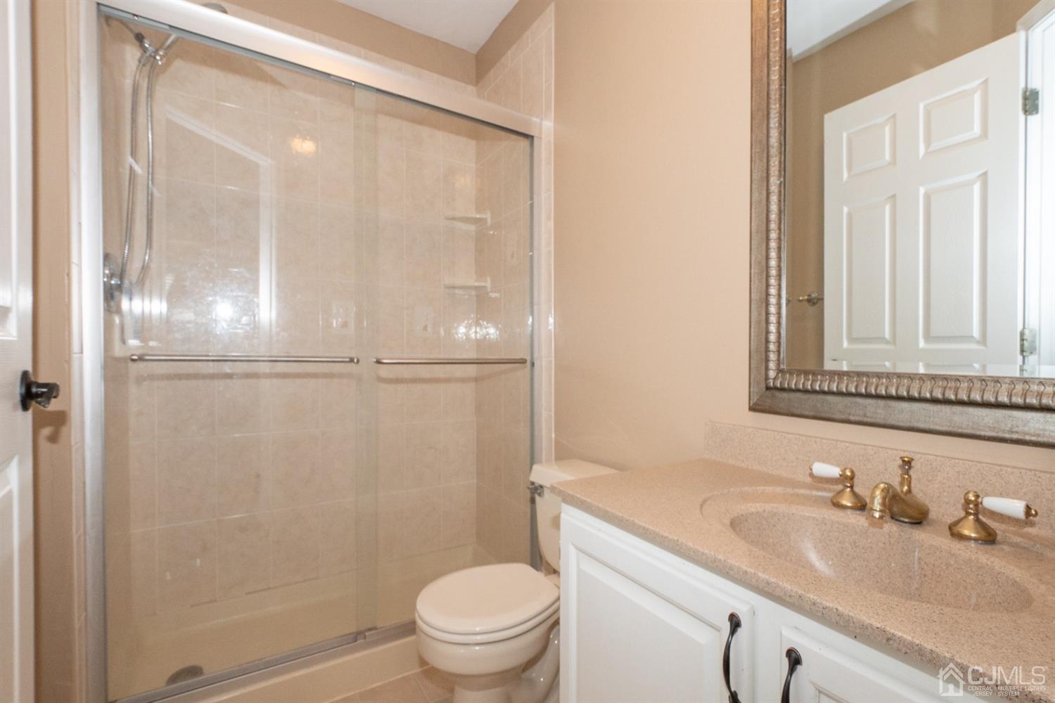 42 Springfield Road North Brunswick, NJ 08902 - Photo 28 of 37 a bathroom with a granite countertop sink toilet and a mirror