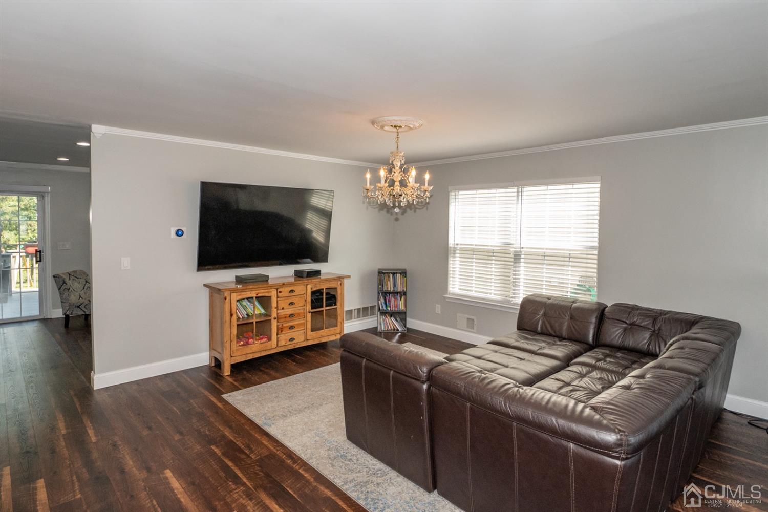42 Springfield Road North Brunswick, NJ 08902 - Photo 5 of 37 a living room with furniture and a flat screen tv
