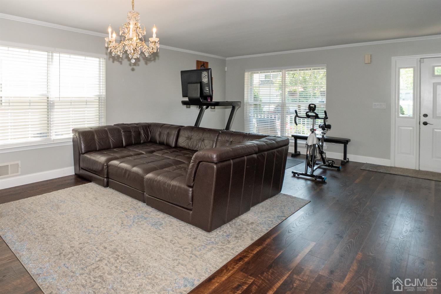 42 Springfield Road North Brunswick, NJ 08902 - Photo 6 of 37 a living room with furniture and a chandelier