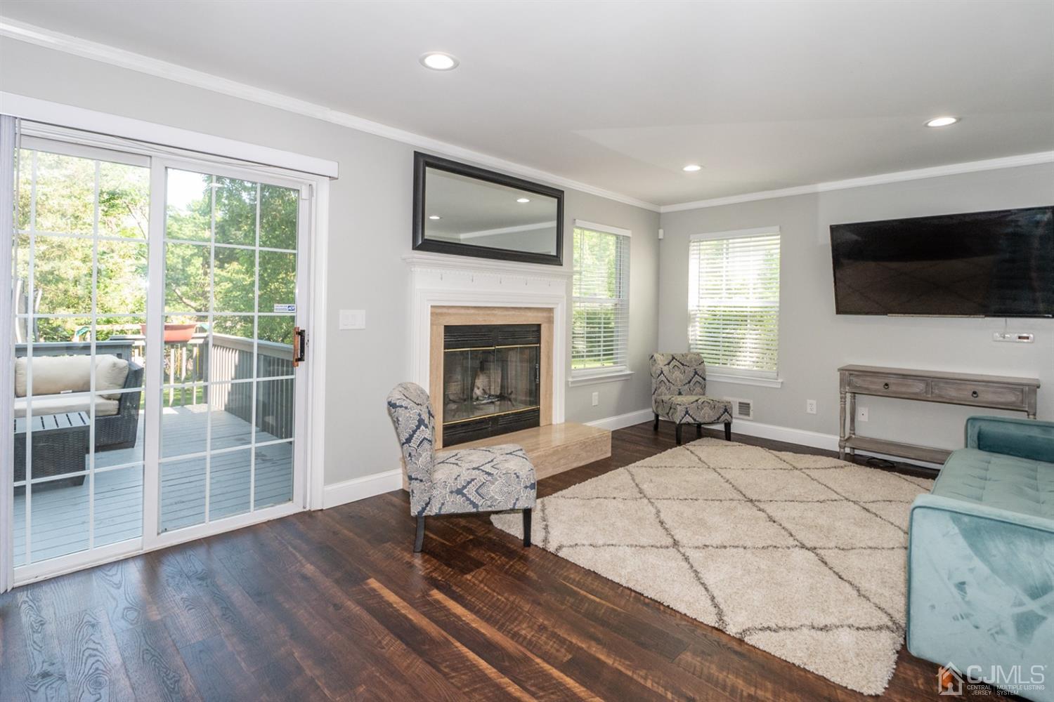 42 Springfield Road North Brunswick, NJ 08902 - Photo 10 of 37 a living room with furniture a flat screen tv and a fireplace