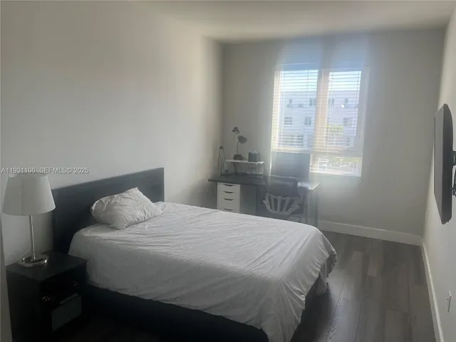 a bedroom with a bed and a night stand