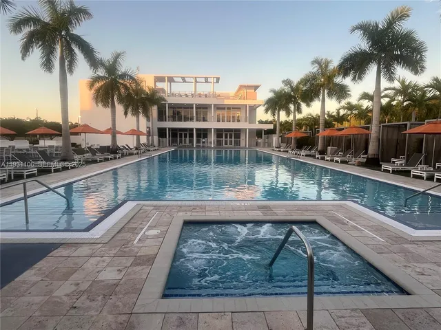 swimming pool view with a seating space