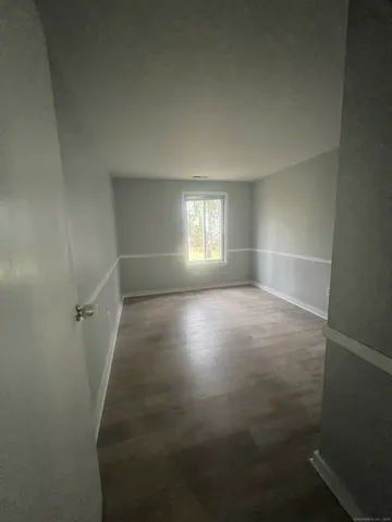 a view of room with window and hardwood floor