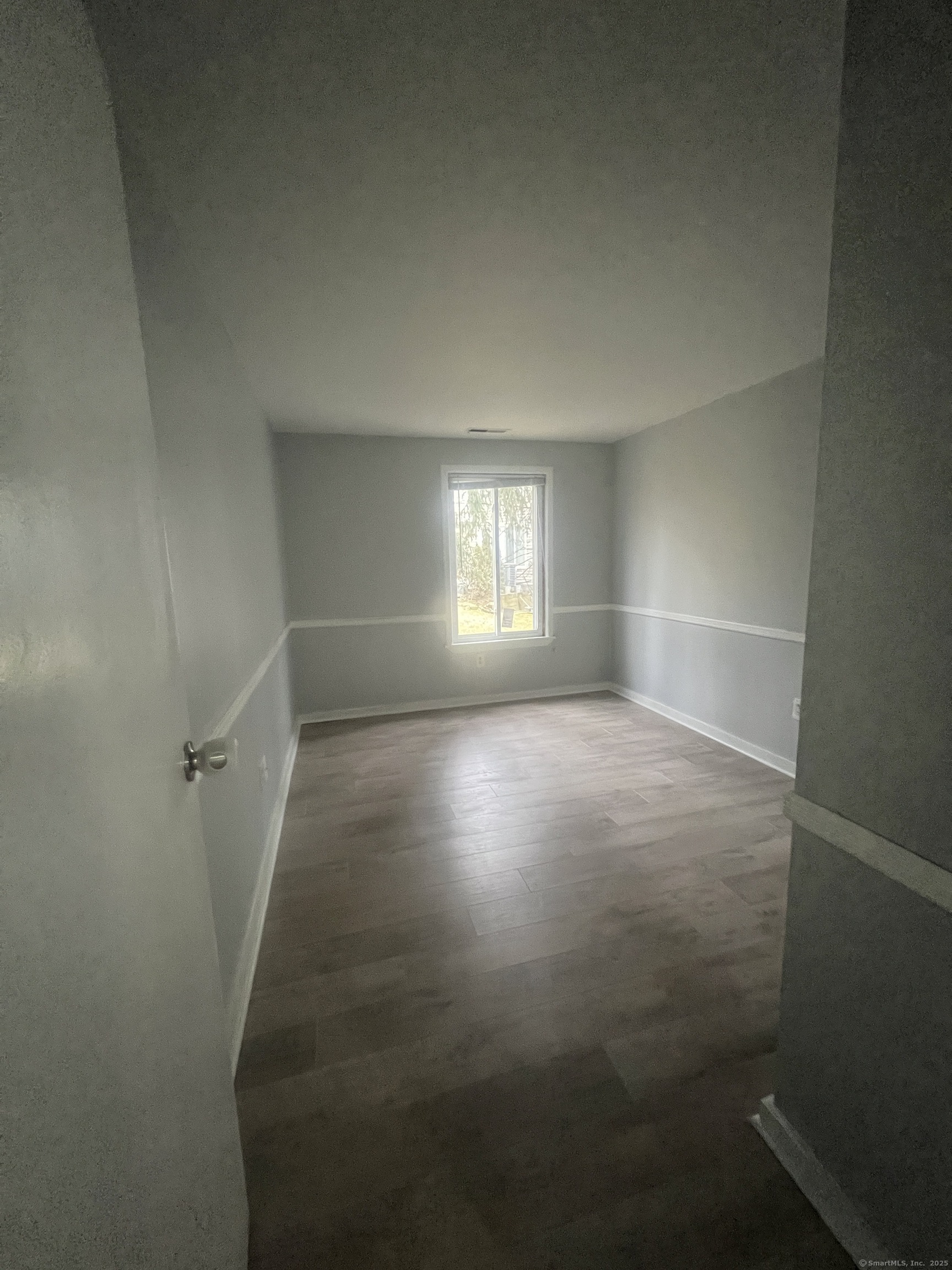 140 Shepard Avenue, Unit 140 Hamden, CT 06514 - Photo 11 of 29 a view of room with window and hardwood floor