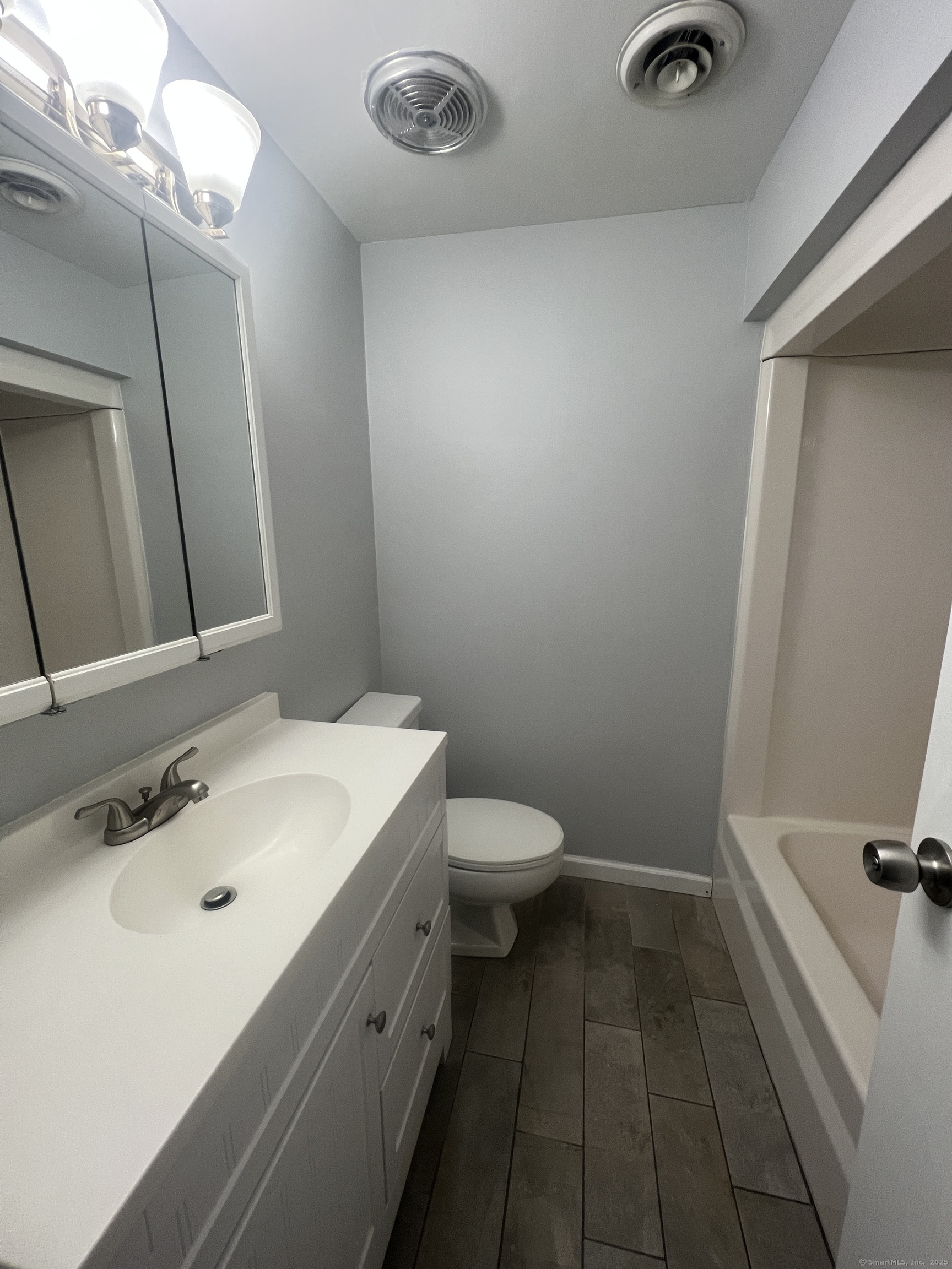 140 Shepard Avenue, Unit 140 Hamden, CT 06514 - Photo 24 of 29 a bathroom with a sink a toilet and mirror