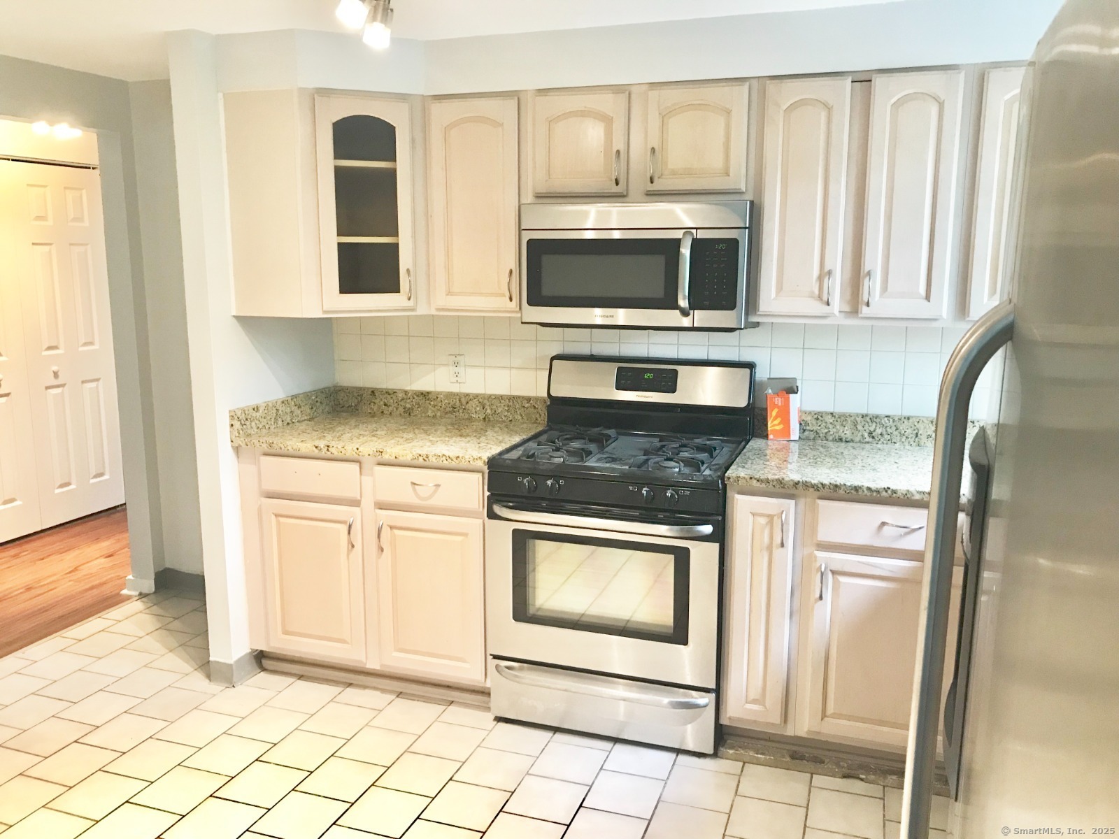 140 Shepard Avenue, Unit 140 Hamden, CT 06514 - Photo 3 of 29 a kitchen with stainless steel appliances granite countertop a stove microwave and refrigerator