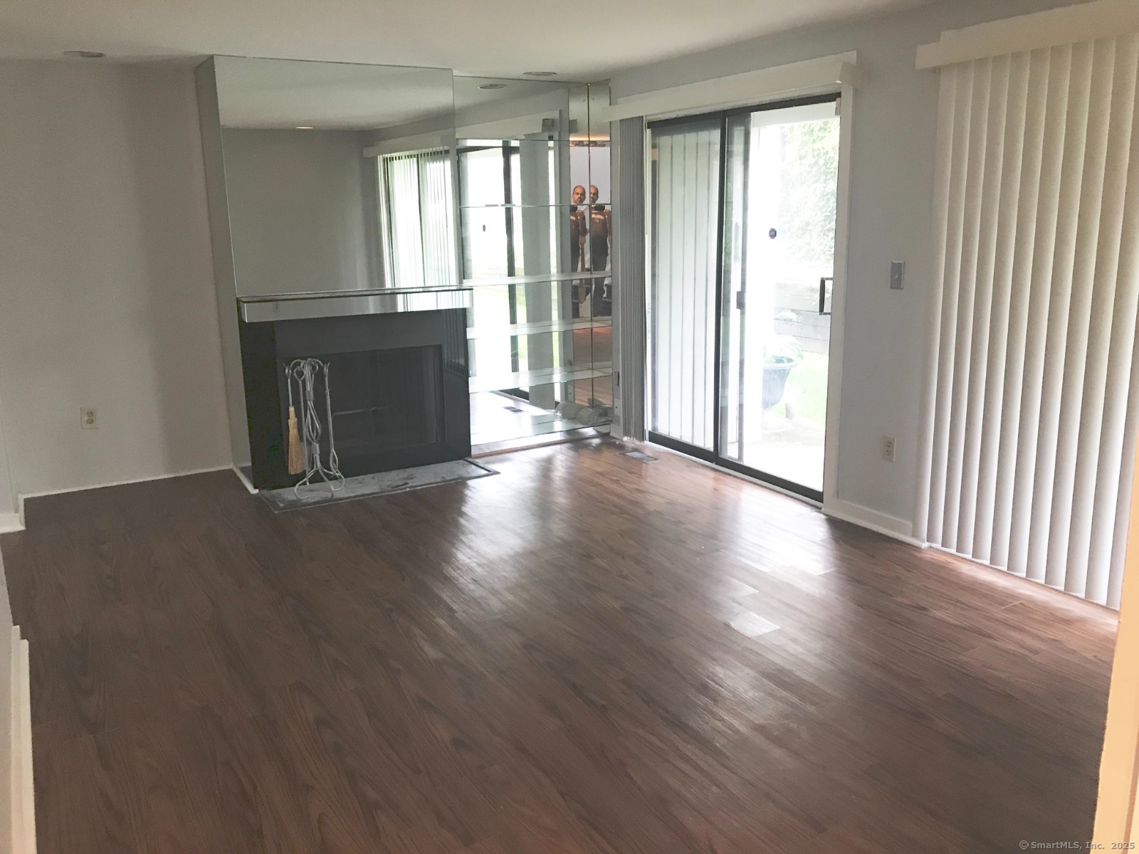 140 Shepard Avenue, Unit 140 Hamden, CT 06514 - Photo 7 of 29 an empty room with wooden floor and windows