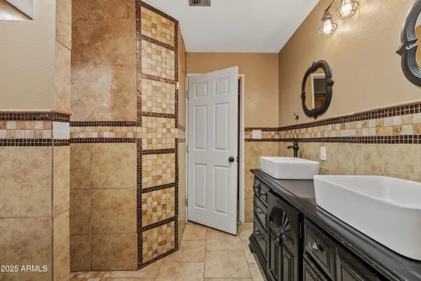 a bathroom with a sink a vanity and a shower