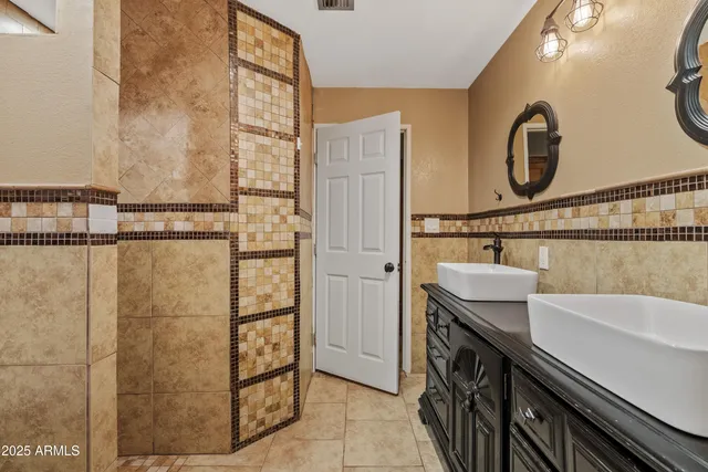 a bathroom with a sink a vanity and a shower