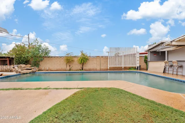 a view of swimming pool with a yard