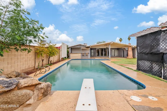a view of a swimming pool with a patio