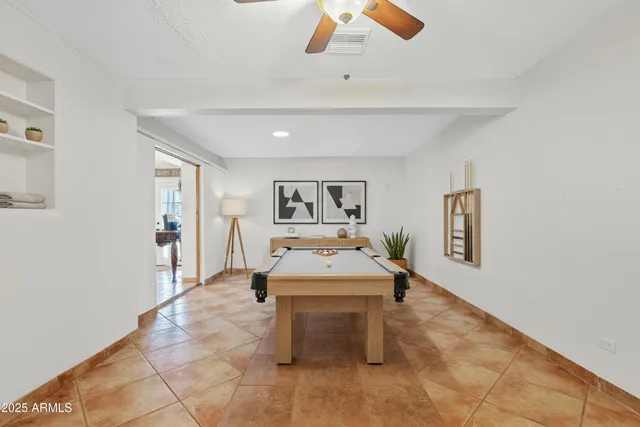 a room with pool table and glass door
