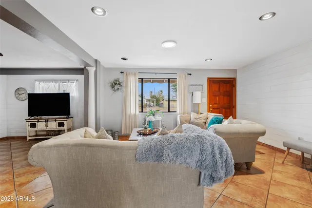 a bedroom with two beds and a flat screen tv