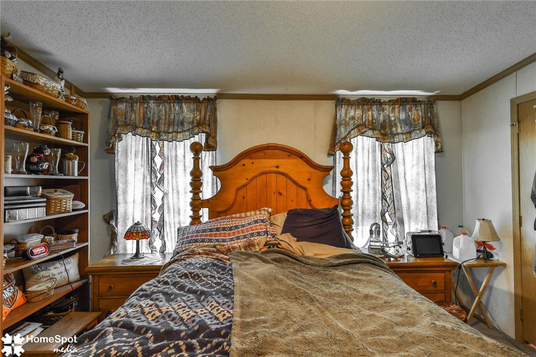 3795 Rhoades Road Kempton, PA 19529 - Photo 14 of 42 A comforting bedroom space featuring a classic wooden headboard and convenient built-in shelving.