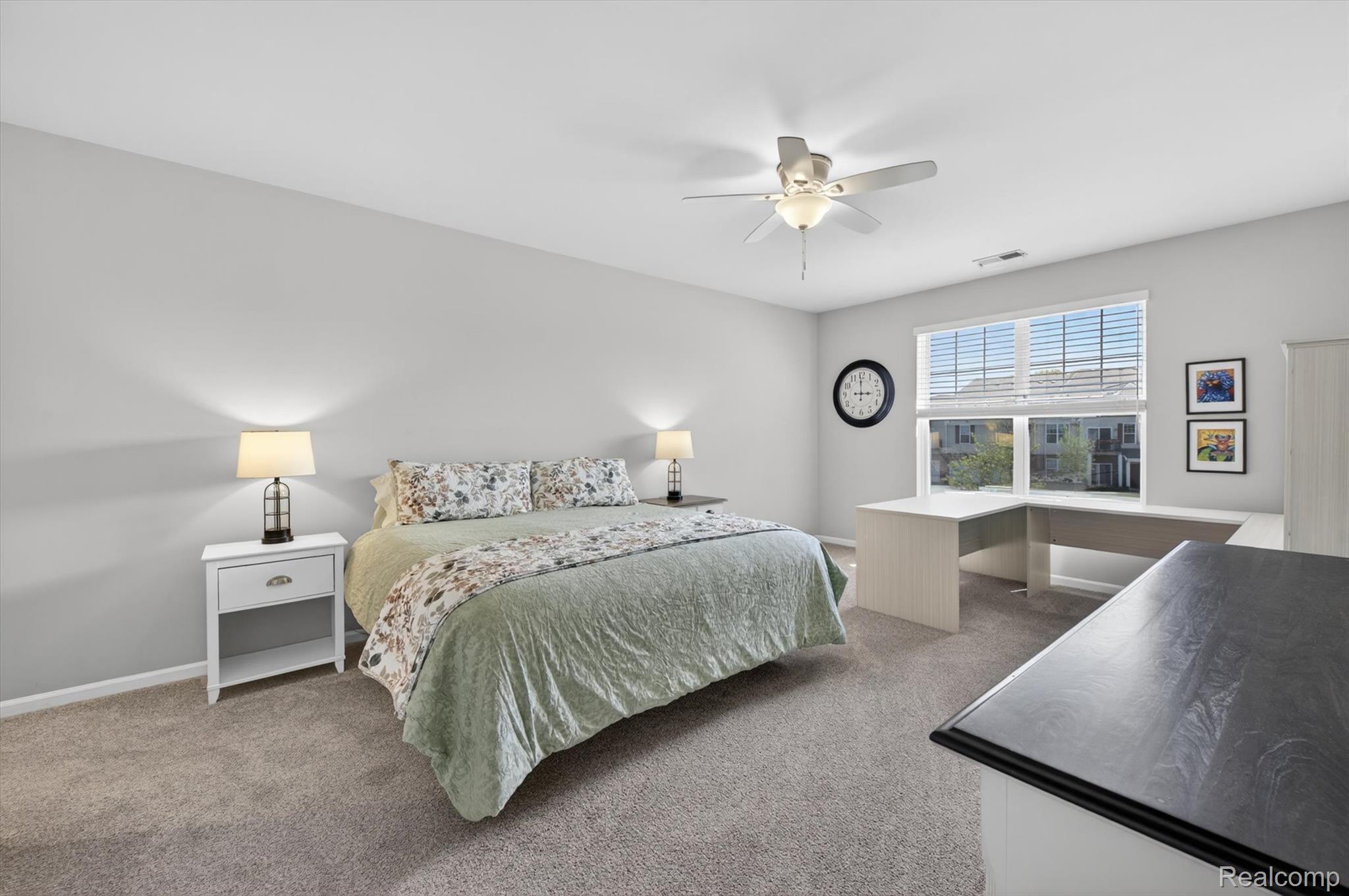 9789 Ridge Run Street Howell, MI 48855 - Photo 14 of 23 Spacious primary bedroom with vaulted ceilings, large windows, and abundant natural light.