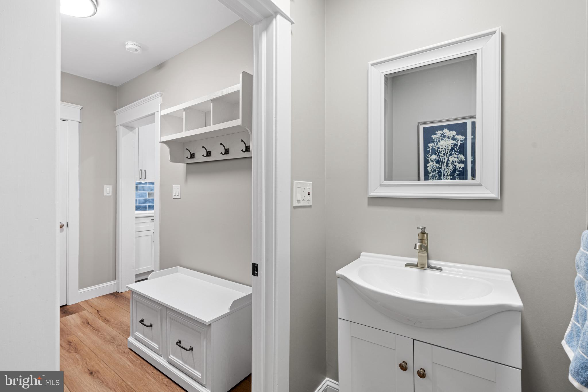 227 7th Avenue Haddon Heights, NJ 08035 - Photo 11 of 26 a bathroom with a sink a mirror and a toilet