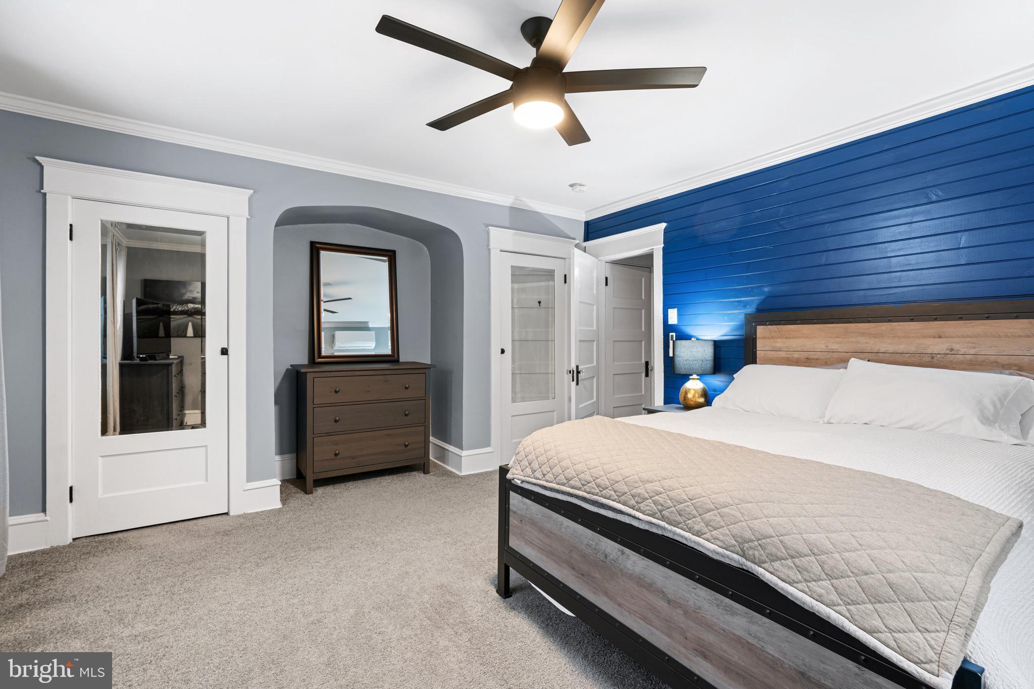 227 7th Avenue Haddon Heights, NJ 08035 - Photo 13 of 26 a bedroom with a bed a dresser and a chandelier